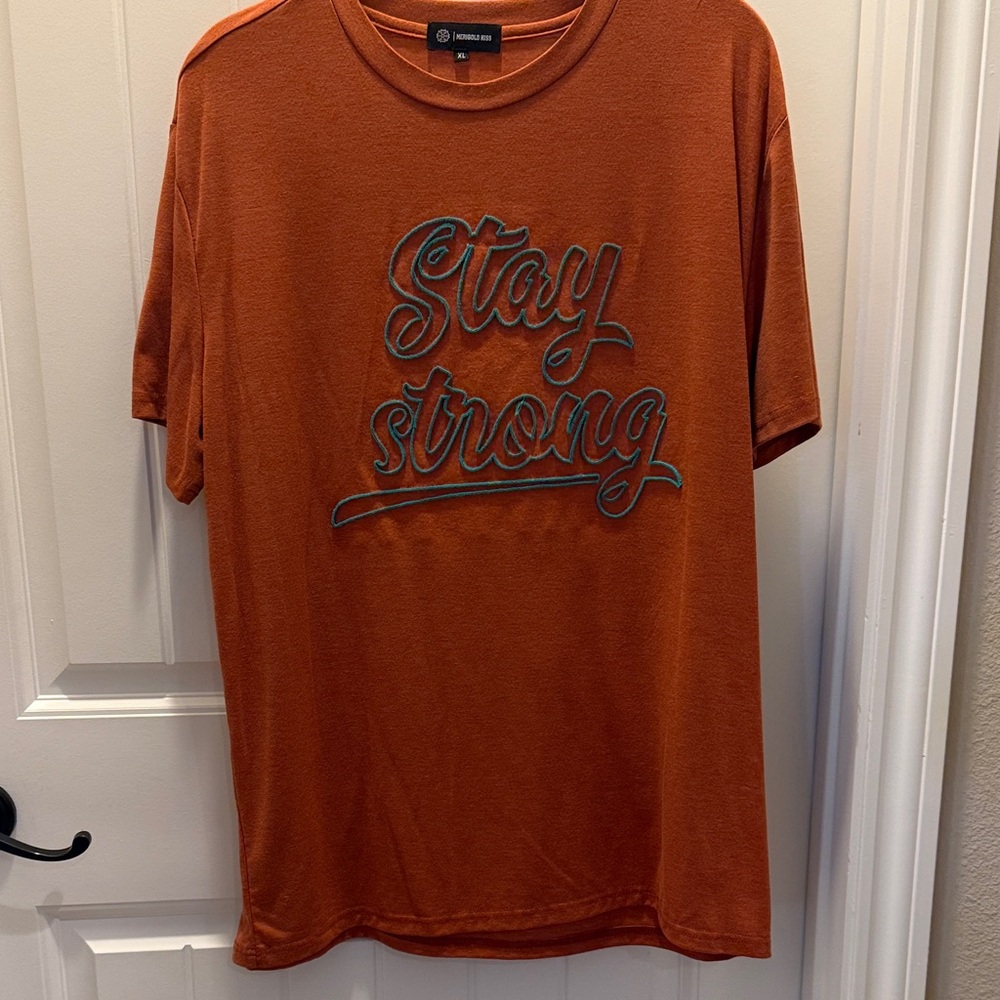 Merigold Kiss Orange w/Teal Letters “Stay Strong” Top (Unisex XL)